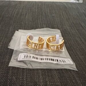 Gold Designer Women's earings reads BALENCIAGA